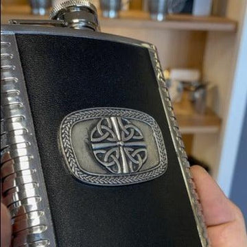 Whiskey flask with trinity knot design